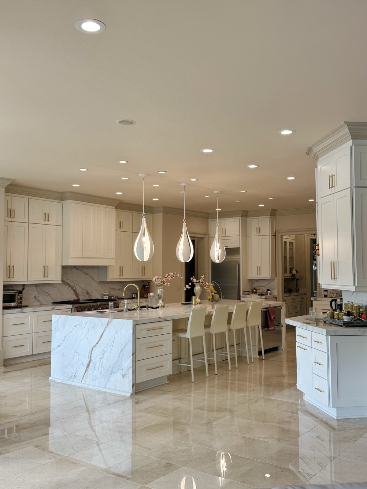Custom white kitchen cabinets with marble island by Matt Cabinet